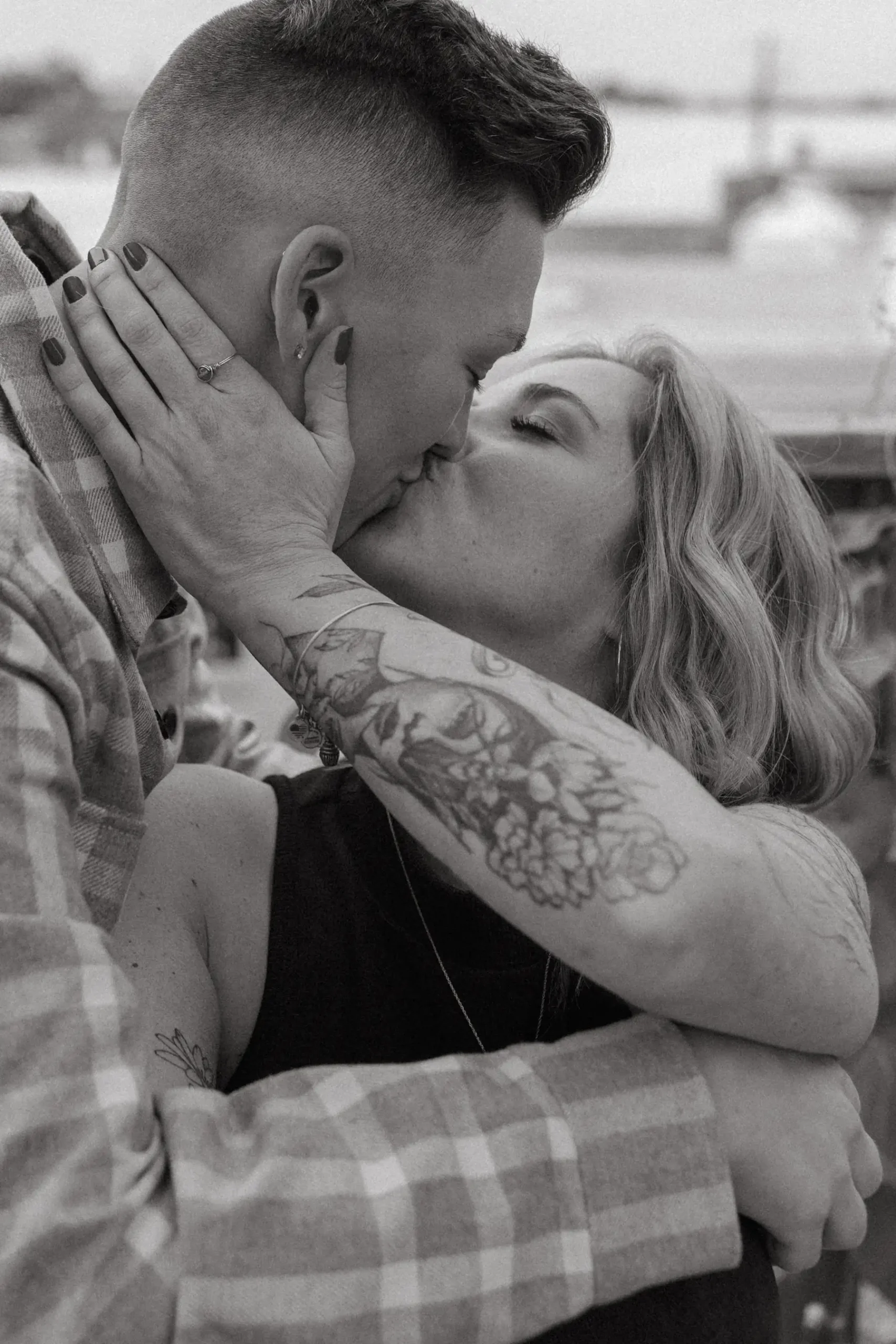 The couple shares a kiss during their engagement session at Gravely Brewing Co in Denver, Colorado.