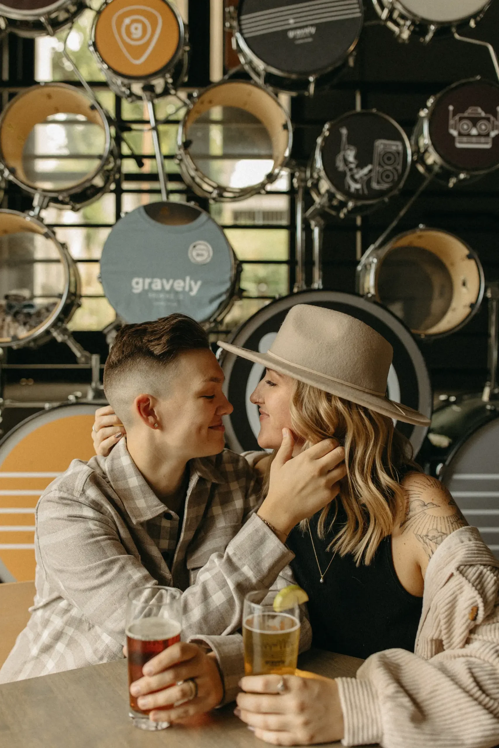 The couple shares a tender moment over craft beers at Gravely Brewing Co in Denver, Colorado.