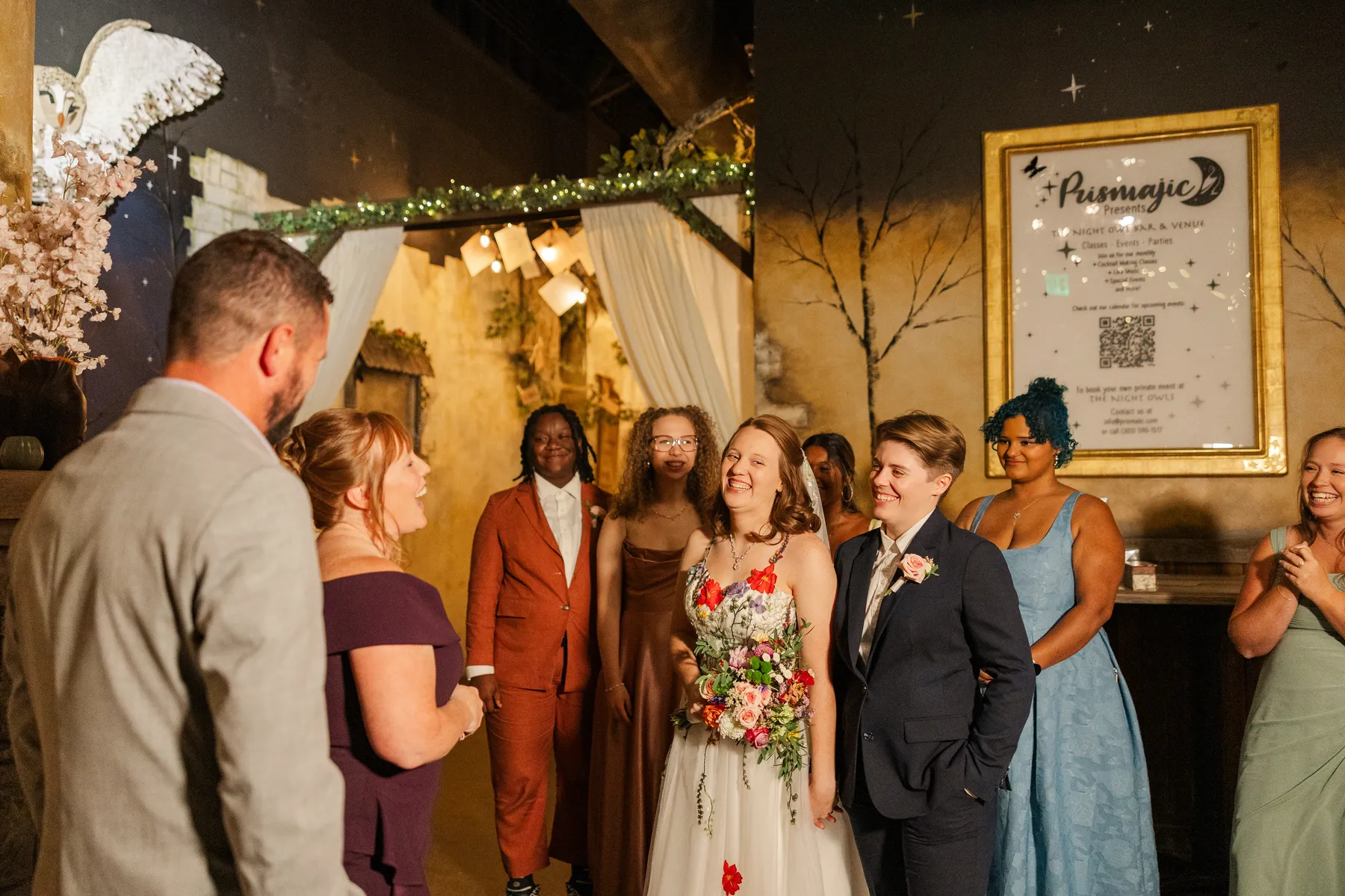 Sydney and Hannah Rusow smile with guests at their wedding reception at Halfway House in Boulder, CO.