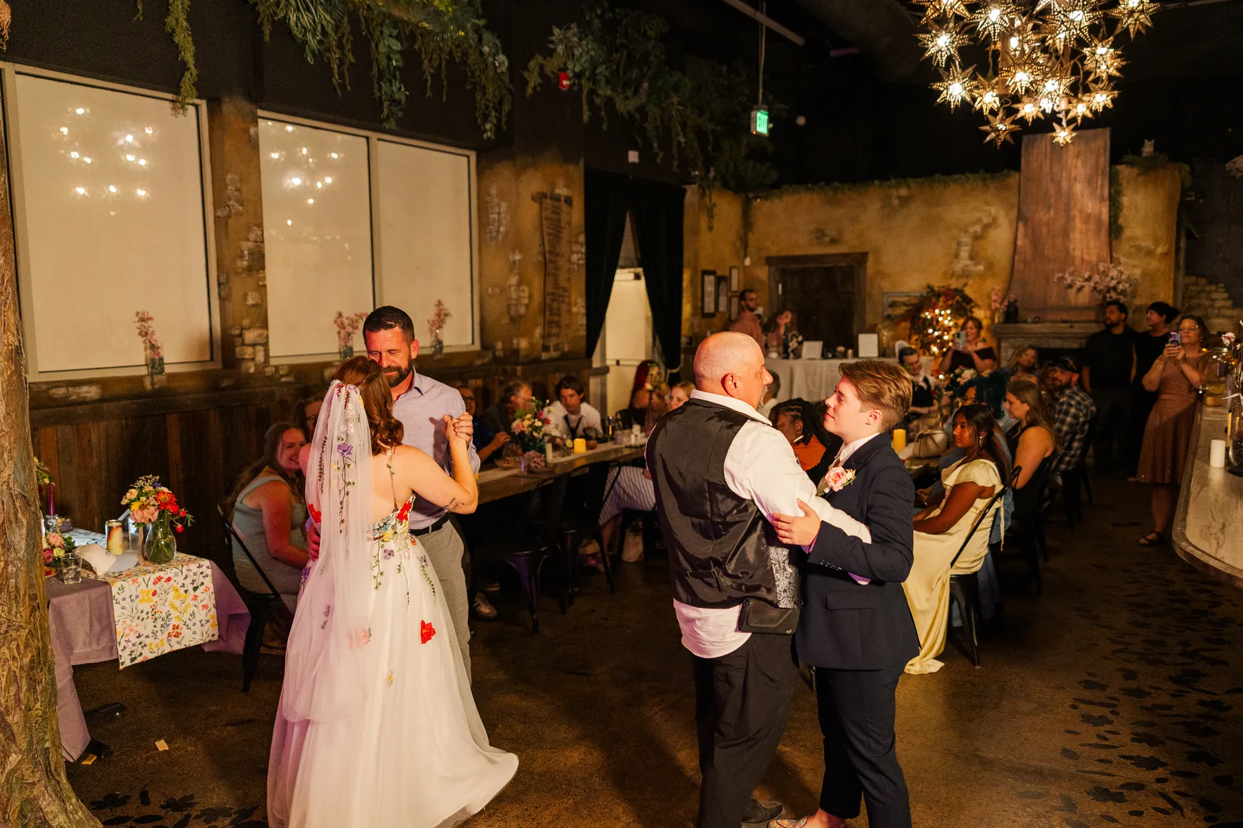 Sydney and Hannah Rusow share a first dance with partners at their wedding reception at Halfway House in Boulder, CO.
