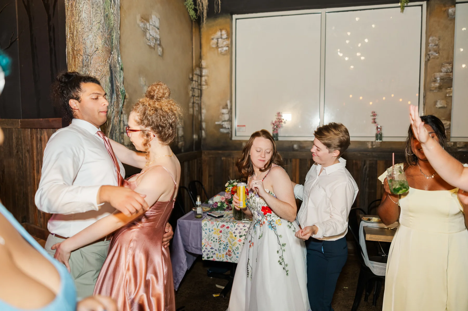 Guests dance with Sydney and Hannah Rusow at their wedding reception at Halfway House in Boulder, CO.
