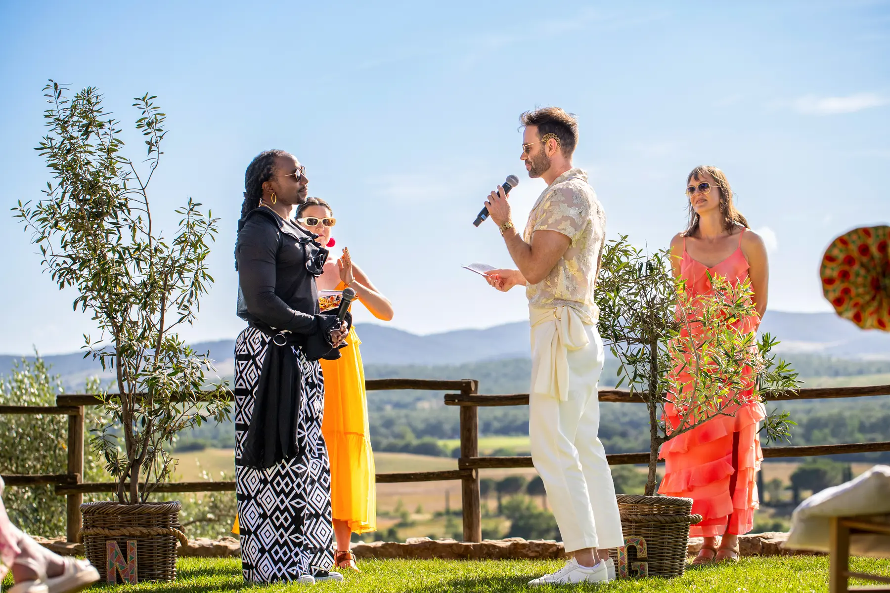 A groom reads vows aloud at an outdoor ceremony at Conti di San Bonifacio Wine Resort in Tuscany, Italy.