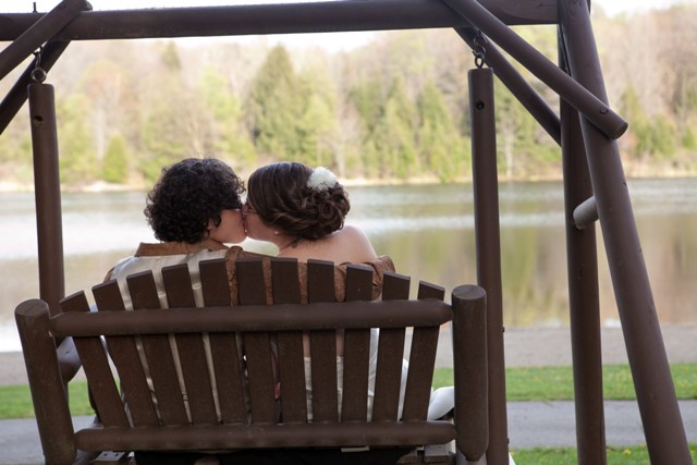 tammy-swales-studio-heather-robbie-nature-lesbian-wedding-outdoors-green-brown-sitting-kissing